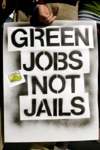 Sign that reads, "Green jobs not jails."